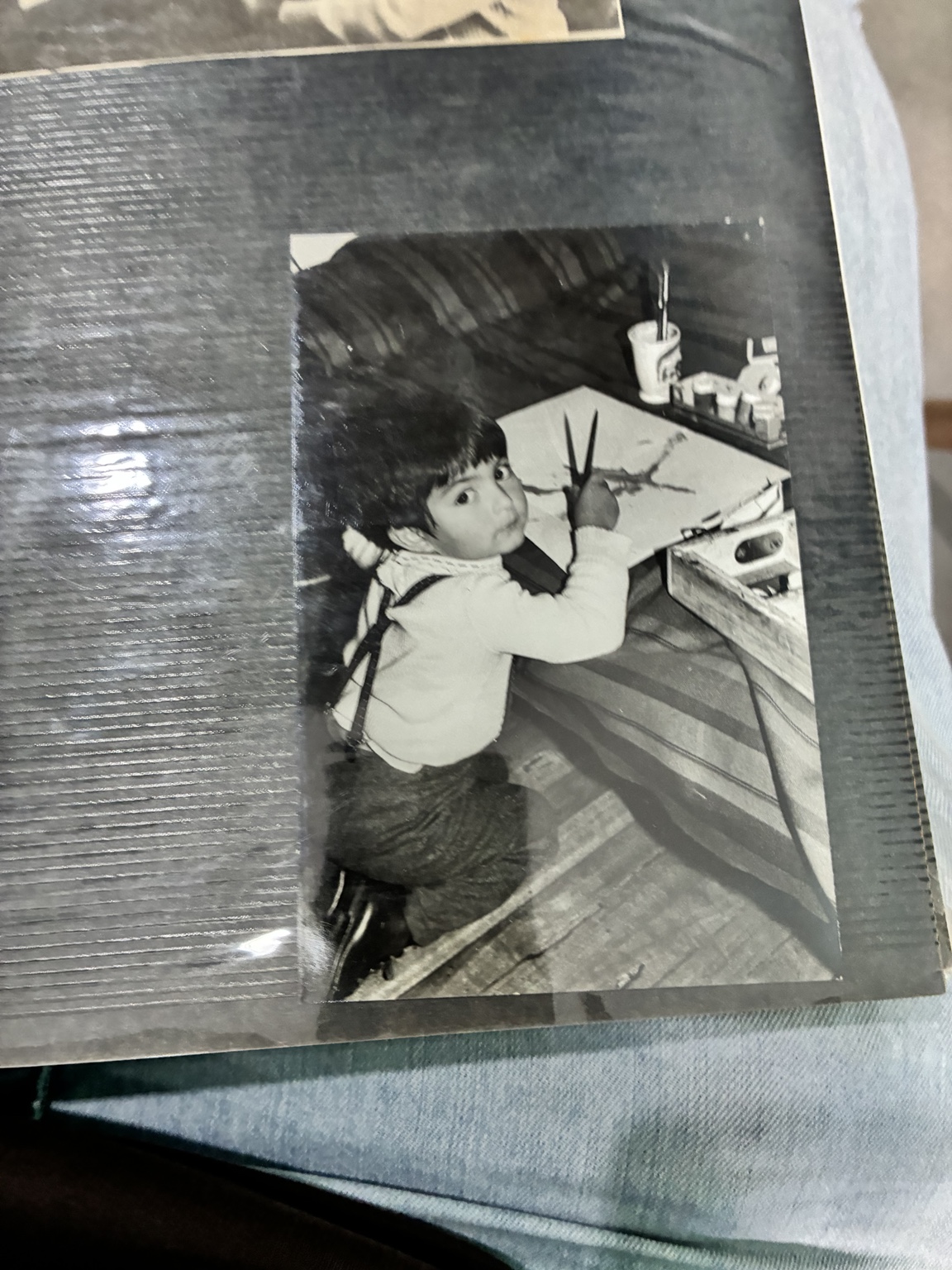 Fotografía de infancia de Ricardo Andrews pintando, conservada en su álbum.